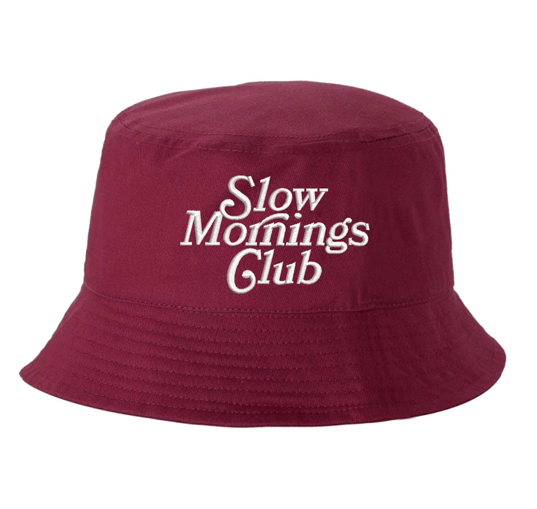 Burgundy Front view of a classic cotton bucket hat featuring the phrase "Slow Morning" in high-density script embroidery. - DSY Lifestyle