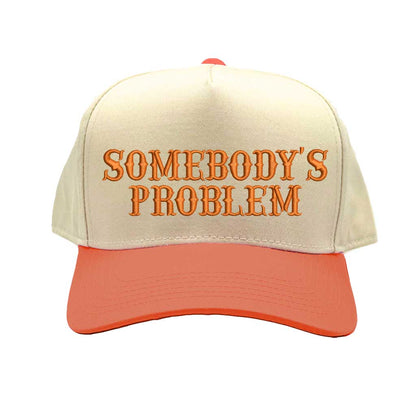 Natural Orange two-tone 5 panel Somebody’s Problem embroidered dad hat with white front panel, beige brim, bold black text, and adjustable strap. – DSY Lifestyle.