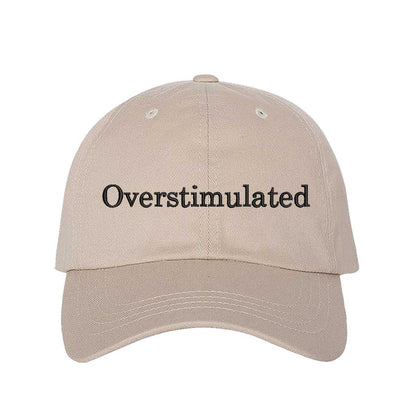 Stone DSY Lifestyle soft cotton baseball hat with the word Overstimulated embroidered in clean, minimalist lowercase lettering across the front. - DSY Lifestyle
