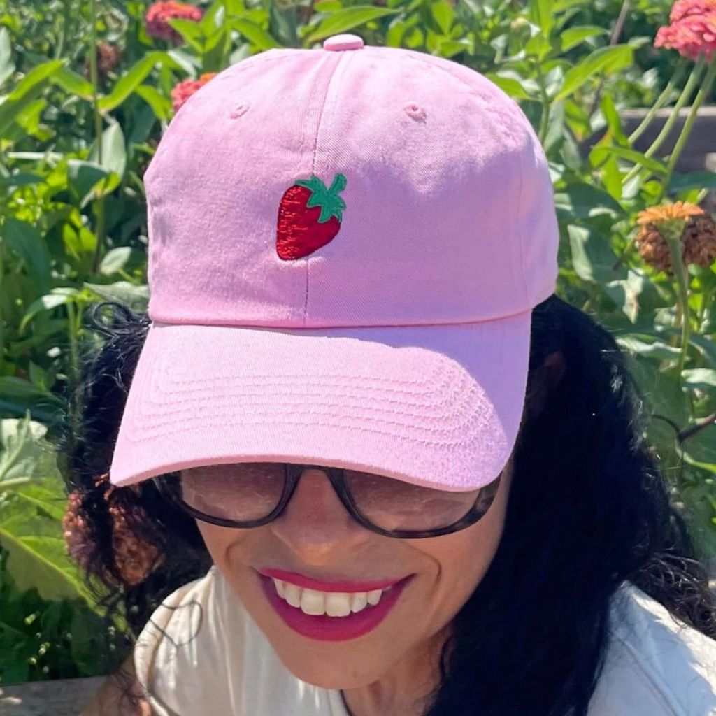 Female wearing a pink baseball cap embroidered with a strawberry fruit - DSY Lifestyle