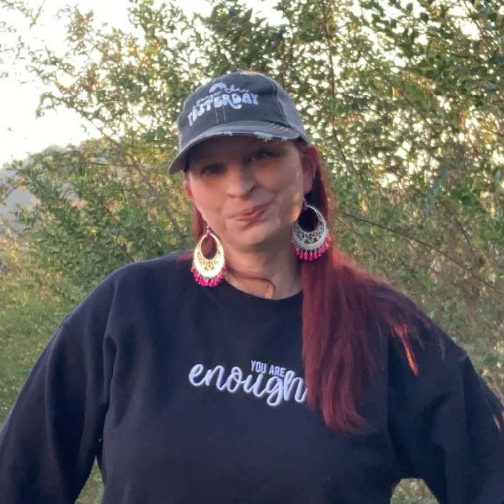 Stronger than Yesterday Trucker hat embroidered women wearing it.
