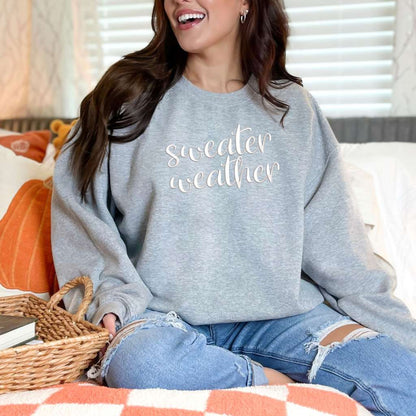 Female wearing a Heather Gray Sweatshirt with sweater weather embroidered in the front - DSY Lifestyle