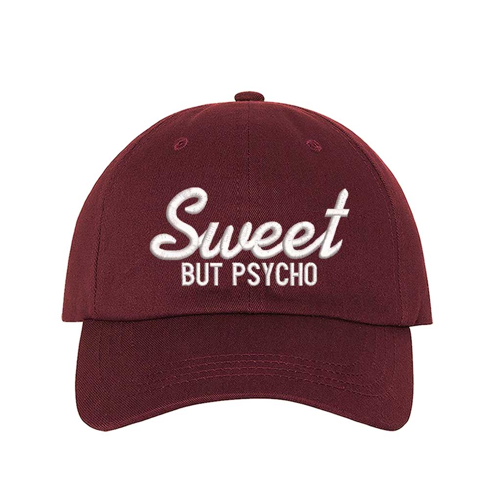 Burgundy Close-up of a DSY Lifestyle baseball hat with "Sweet But Psycho" embroidered in a clean, modern font; a funny statement gift for her.