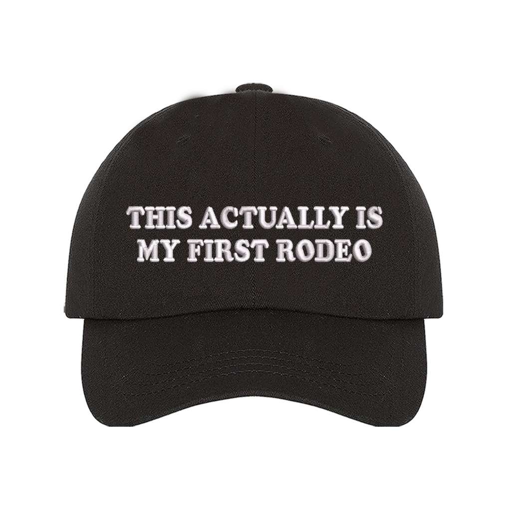 Black baseball hat with the phrase this actually is my first rodeo embroidered on it- DSY Lifestyle