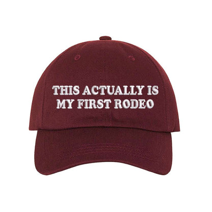 Burgundy baseball hat with the phrase this actually is my first rodeo embroidered on it- DSY Lifestyle