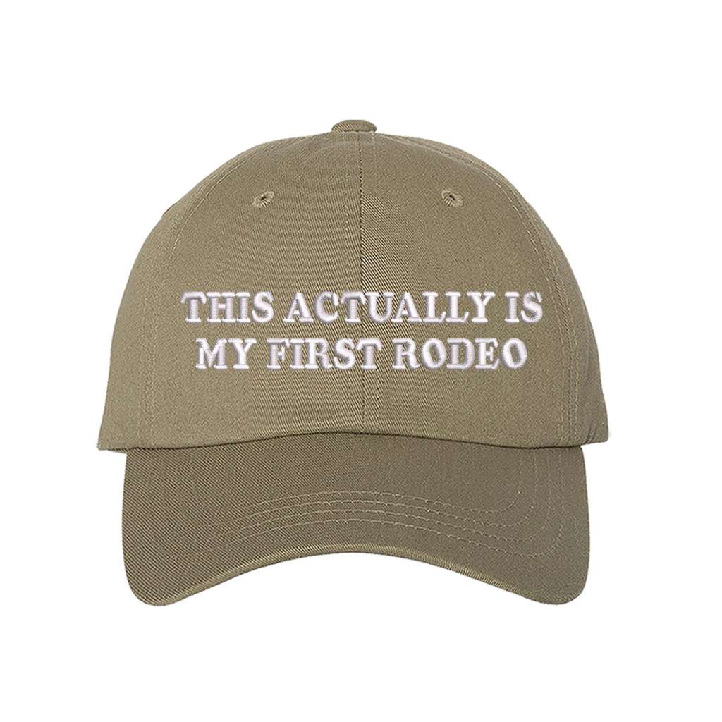 Khaki baseball hat with the phrase this actually is my first rodeo embroidered on it- DSY Lifestyle