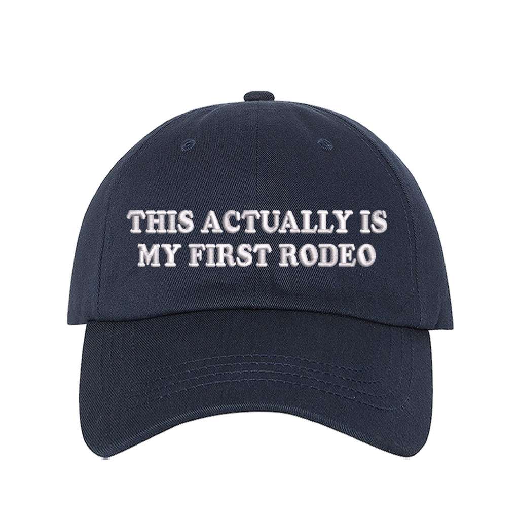 Navy blue baseball hat with the phrase this actually is my first rodeo embroidered on it- DSY Lifestyle