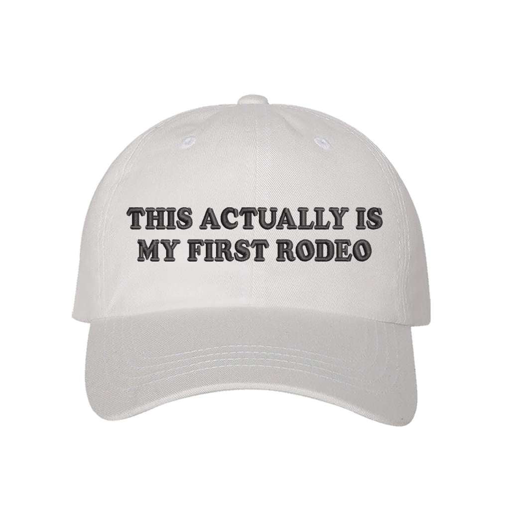 White baseball hat with the phrase this actually is my first rodeo embroidered on it- DSY Lifestyle