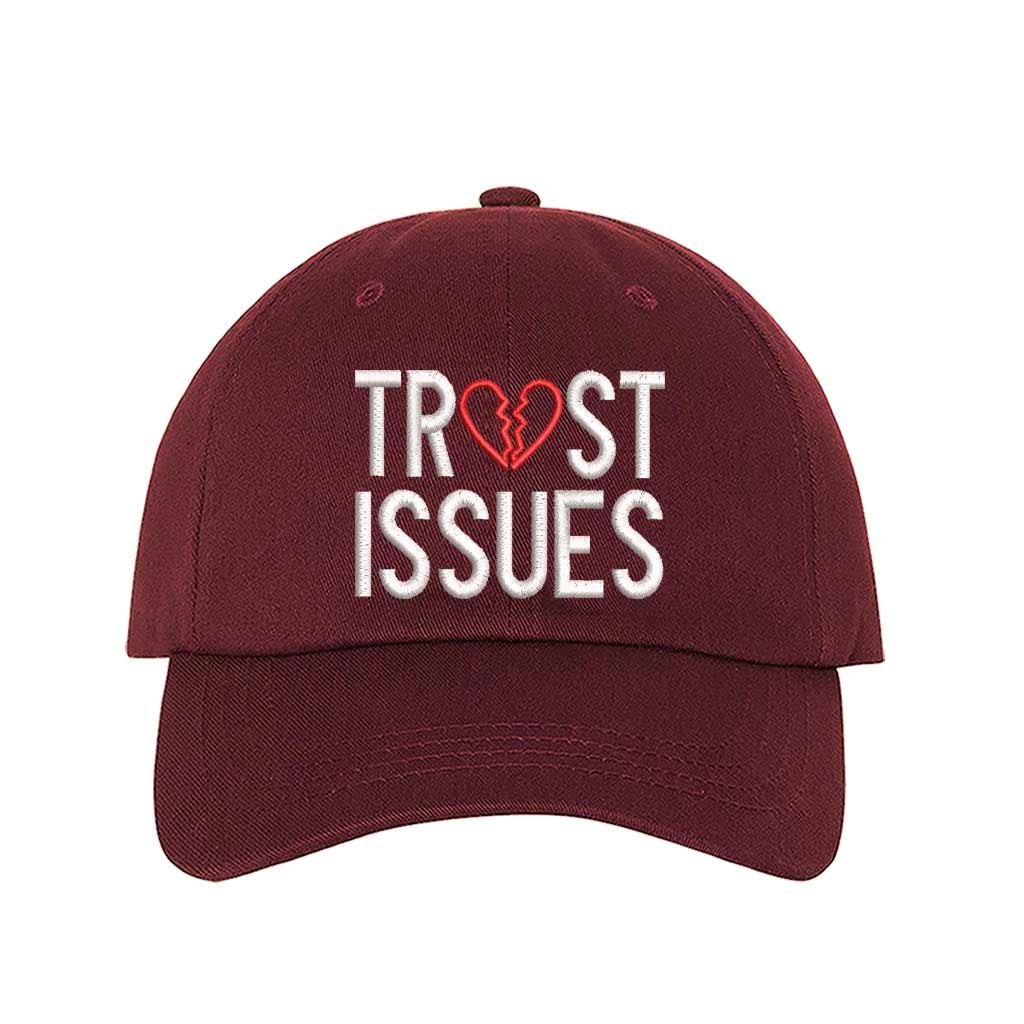 Burgundy Trust Issues Baseball Hat featuring "Trust Issues" embroidered in a bold font on a classic dad cap; a funny and relatable statement accessory from DSY Lifestyle.