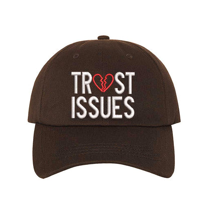 Brown Trust Issues Baseball Hat featuring "Trust Issues" embroidered in a bold font on a classic dad cap; a funny and relatable statement accessory from DSY Lifestyle.