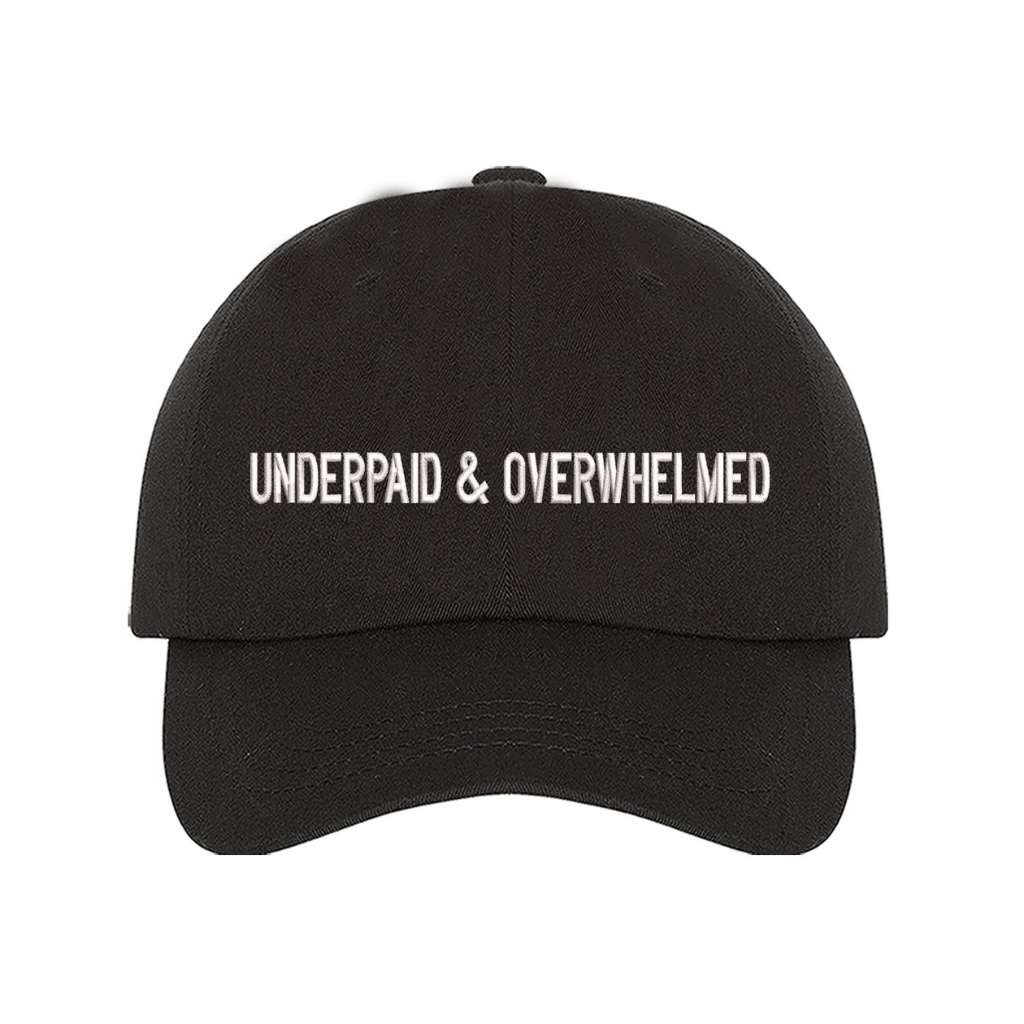 Black baseball hat with the phrase underpaid &amp; overwhelmed embroidered on it-DSY Lifestyle