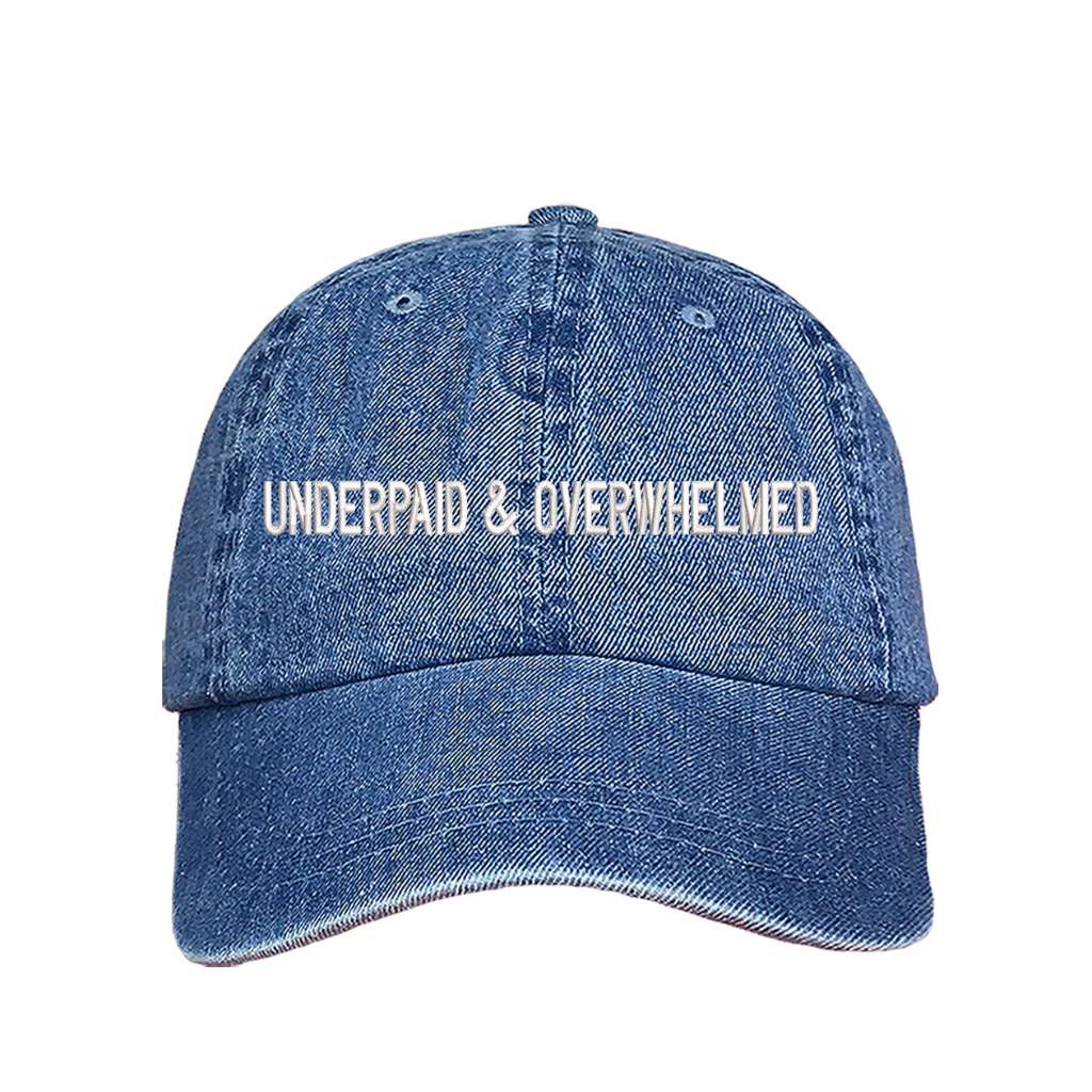 Denim baseball hat with the phrase underpaid &amp; overwhelmed embroidered on it-DSY Lifestyle