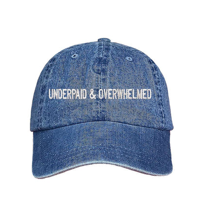 Denim baseball hat with the phrase underpaid &amp; overwhelmed embroidered on it-DSY Lifestyle