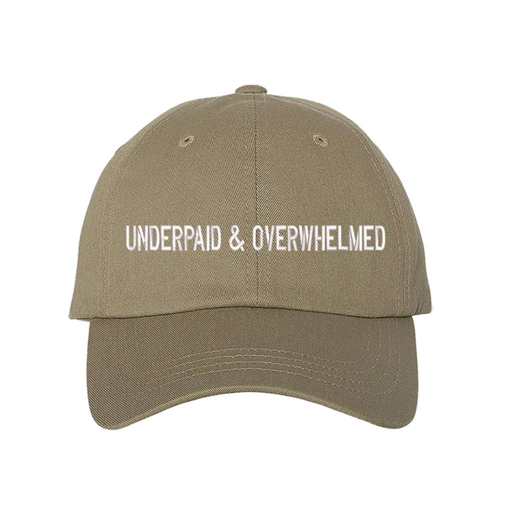 Khaki baseball hat with the phrase underpaid &amp; overwhelmed embroidered on it-DSY Lifestyle