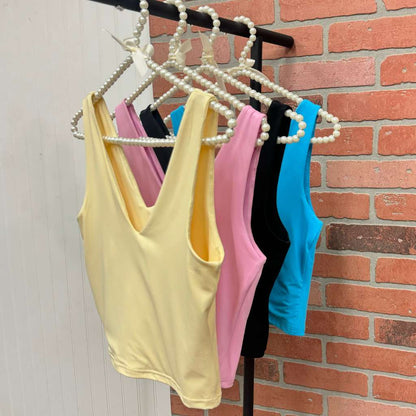 All vneck top Black soft yellow ocean blue and light pink on hangers- DSY Lifestyle