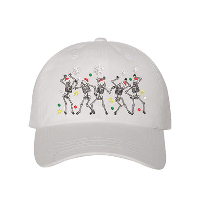 White Dancing Skeletons Christmas Embroidered Baseball Hat featuring festive dancing skeleton embroidery and adjustable hook and loop closure – DSY Lifestyle.