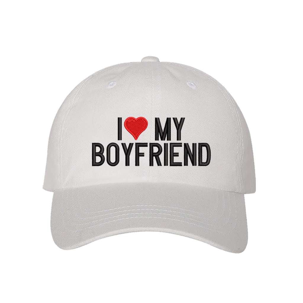 White baseball hat embroidered with the phrase I love my boyfriend but love is a heart- DSY Lifestyle