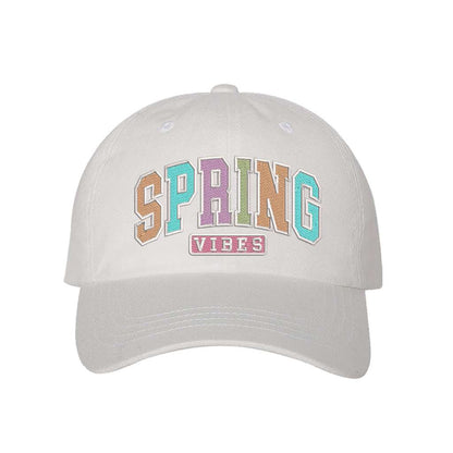White baseball hat embroidered with the phrase spring vibes on it- DSY Lifestyle
