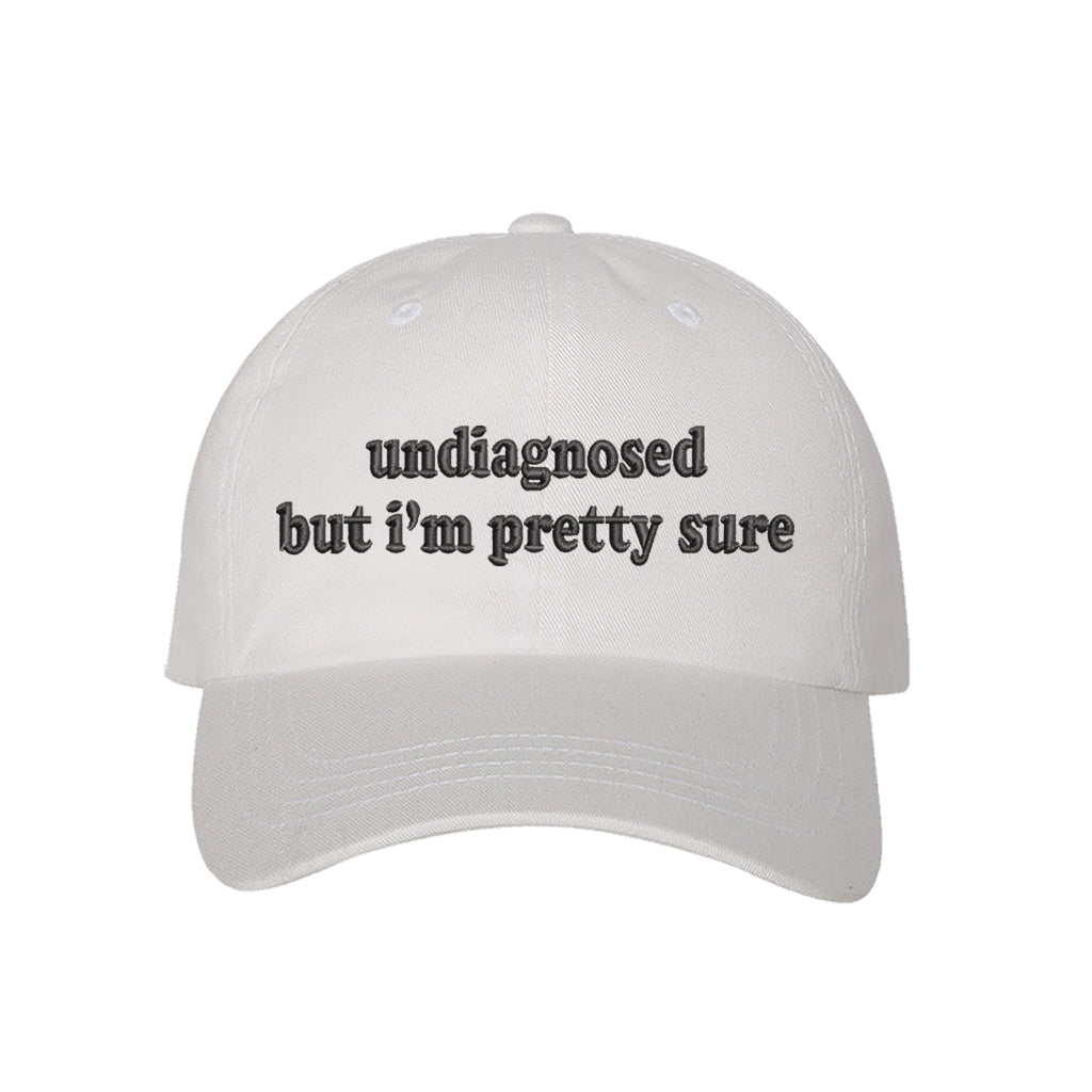 White baseball hat embroidered with the phrase undiagnosed but im pretty sure-DSY Lifestyle