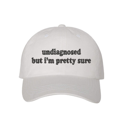 White baseball hat embroidered with the phrase undiagnosed but im pretty sure-DSY Lifestyle