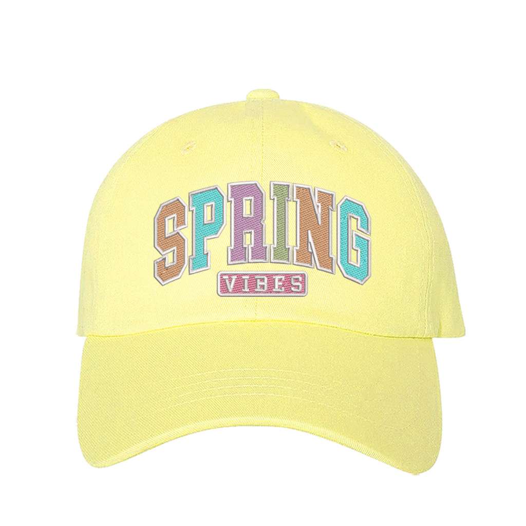 Yellow baseball hat embroidered with the phrase spring vibes on it- DSY Lifestyle