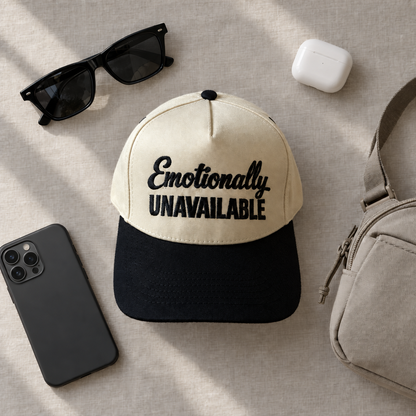 Emotionally Unavailable two-tone embroidered trucker hat styled flat lay