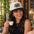 Model wearing the Fueled by Cafecito y Chisme embroidered two-tone trucker hat