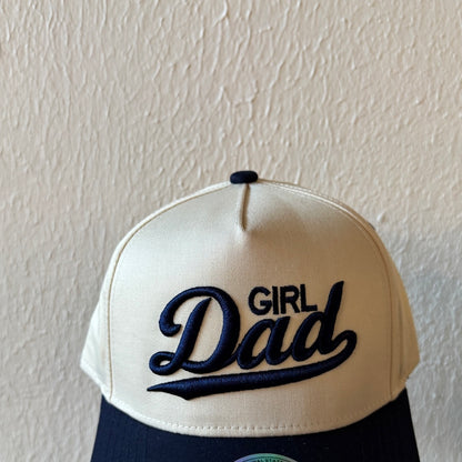 Close-up of Girl Dad machine embroidery on a two-tone trucker hat