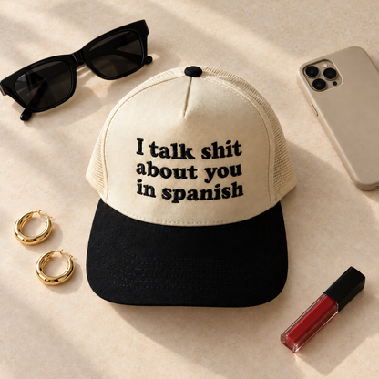 I Talk Shit About You In Spanish two-tone embroidered trucker hat styled flat lay