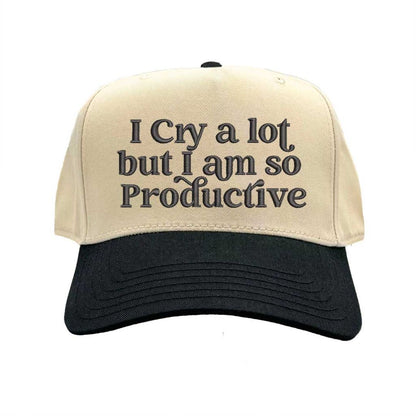 Natural Black Two-tone embroidered baseball hat with “I Cry A Lot But I’m So Productive” stitched in bold lettering, styled on a casual outfit for emotional but driven energy. - DSY Lifestyle