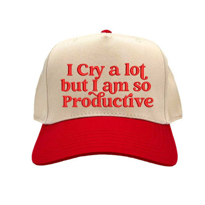 Natural Red Two-tone embroidered baseball hat with “I Cry A Lot But I’m So Productive” stitched in bold lettering, styled on a casual outfit for emotional but driven energy. - DSY Lifestyle