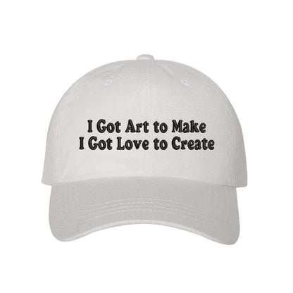 White baseball hat embroidered with the phrase I Got Art to Make I Got Love to Create - DSY Lifestyle
