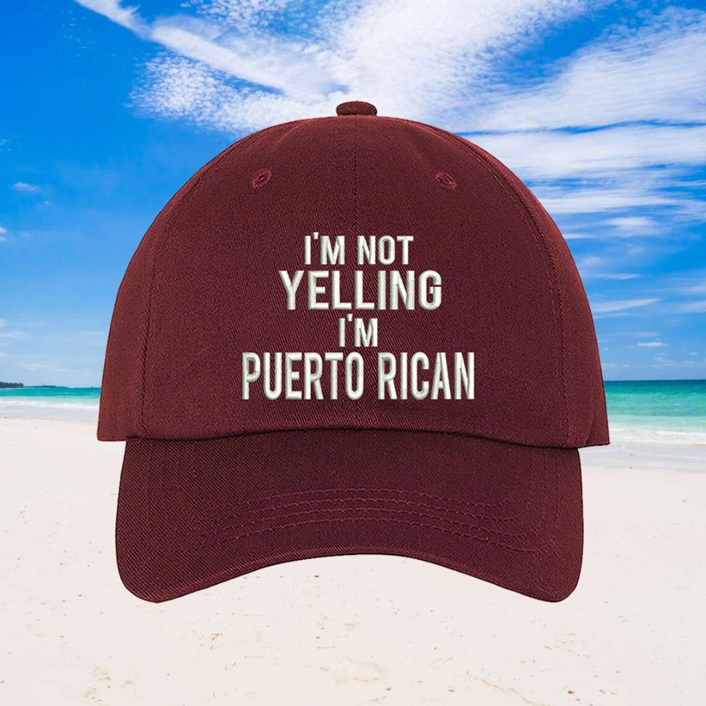 Burgundy stylish baseball hat with I'm Not Yelling, I'm Puerto Rican embroidered on the front, featuring an adjustable strap and soft cotton fabric for a bold, comfortable look.