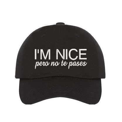 Black I’m Nice Pero No Te Pases Embroidered Baseball Hat in soft cotton with curved brim and hook and loop closure. DSY Lifestyle.