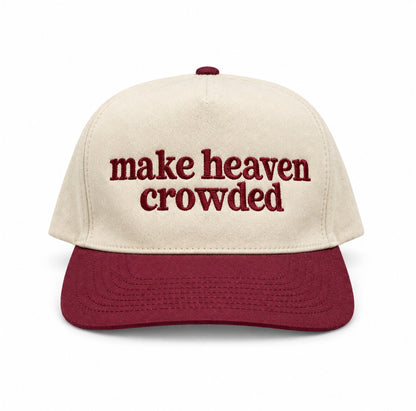 Make heaven crowded embroidered trucker hat with natural crown and maroon bill on a white background