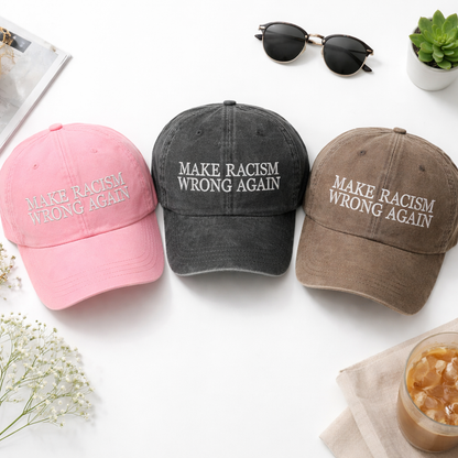 Flat lay of Pink, Black , and Chocolate Brown DSY Lifestyle washed cotton baseball hats featuring the phrase Make Racism Wrong Again in bold, professional embroidery. - DSY Lifestyle
