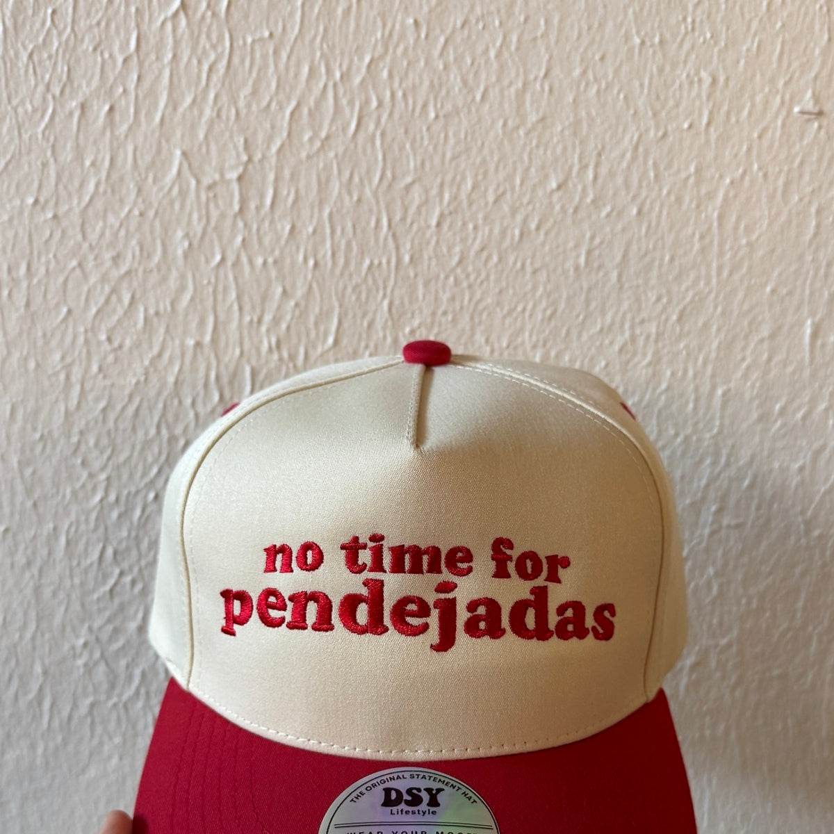 Close-up of No Time for Pendejadas machine embroidery on a two-tone trucker hat