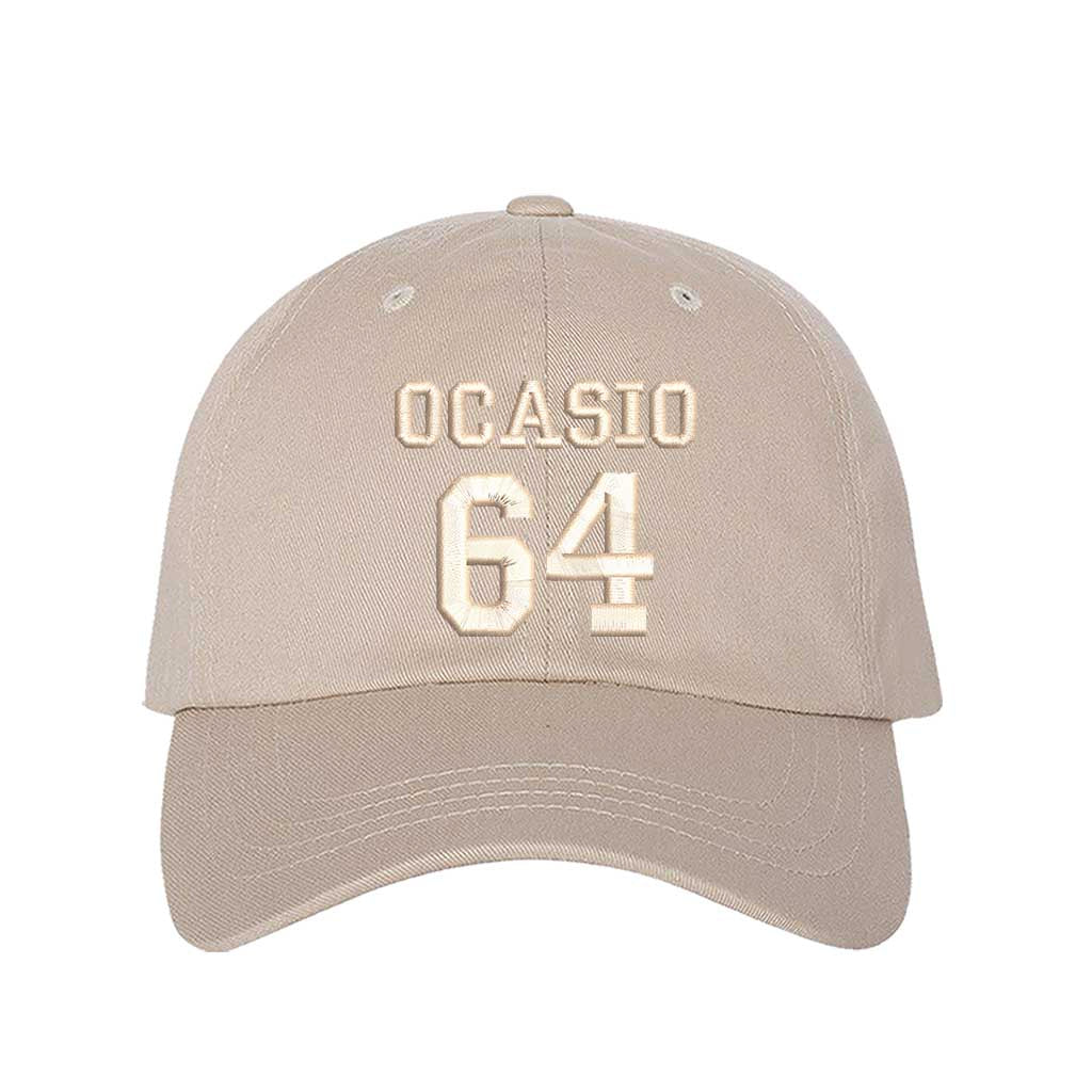 Tone on tone stone baseball hat with OCASIO 64 embroidery flat lay product photo neutral statement cap DSY Lifestyle
