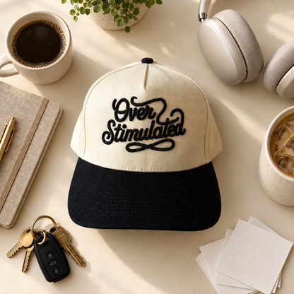 Over Stimulated two-tone embroidered trucker hat styled flat lay