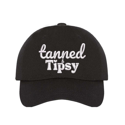 Black Tanned and Tipsy Embroidered Baseball Hat in classic cotton with pre-curved brim and hook and loop closure, perfect for beach days and summer drinks. DSY Lifestyle.