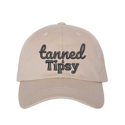 Stone Tanned and Tipsy Embroidered Baseball Hat in classic cotton with pre-curved brim and hook and loop closure, perfect for beach days and summer drinks. DSY Lifestyle.