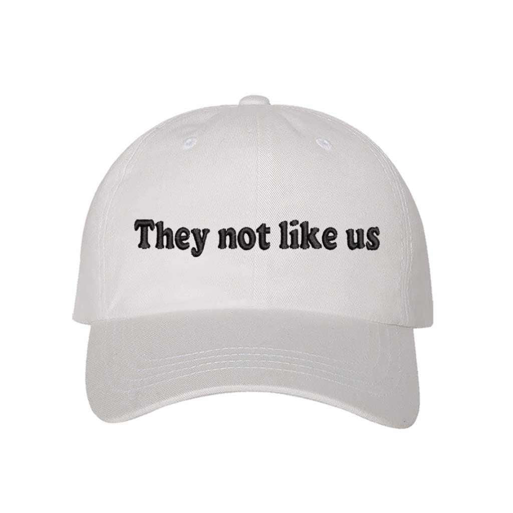 White baseball hat embroidered with the phrase They Not Like Us -DSY Lifestyle