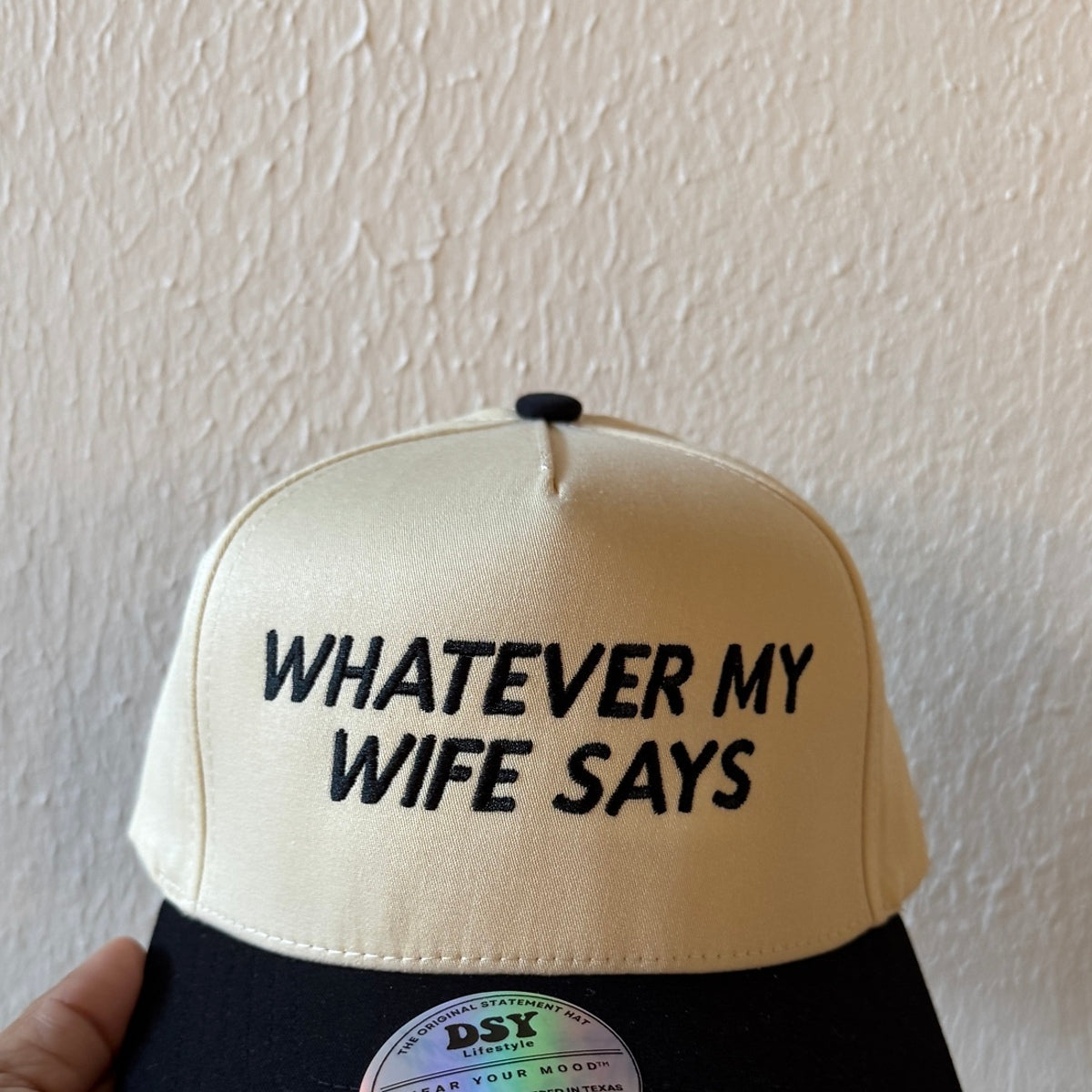Close-up of Whatever My Wife Says machine embroidery on a two-tone trucker hat
