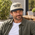 Model wearing the Whatever My Wife Says embroidered two-tone trucker hat