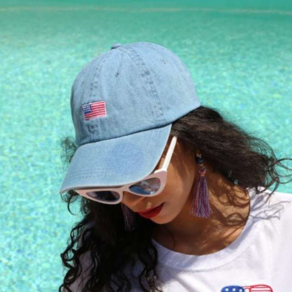 Model wearing light denim baseball hat with USA Flag embroidered on the front - DSY Lifestyle