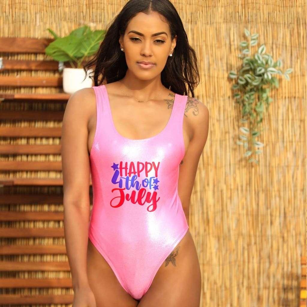 Model wearing pink metallic swimsuit with Happy 4th of July printed on the front - DSY Lifestyle 