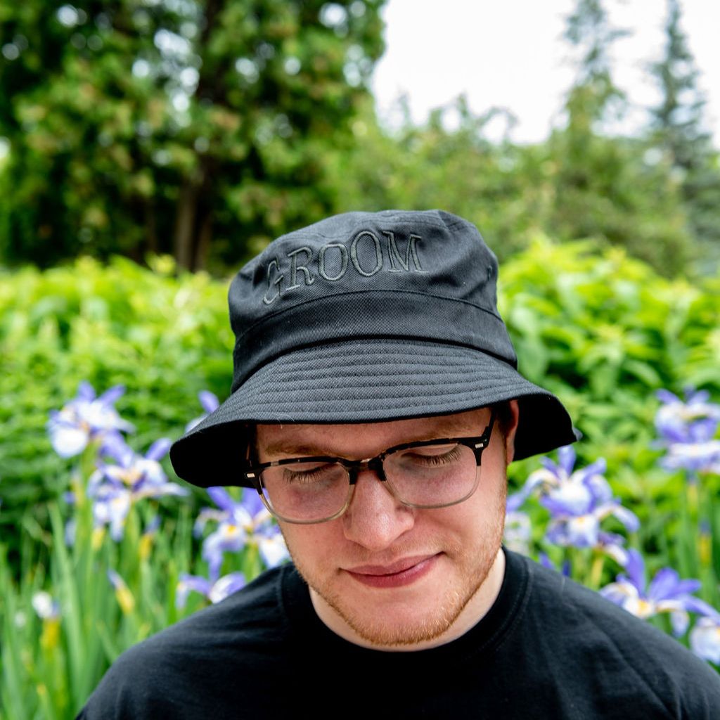 Male wearing a black bucket hat embroidered with Groom in black thread - DSY Lifestyle