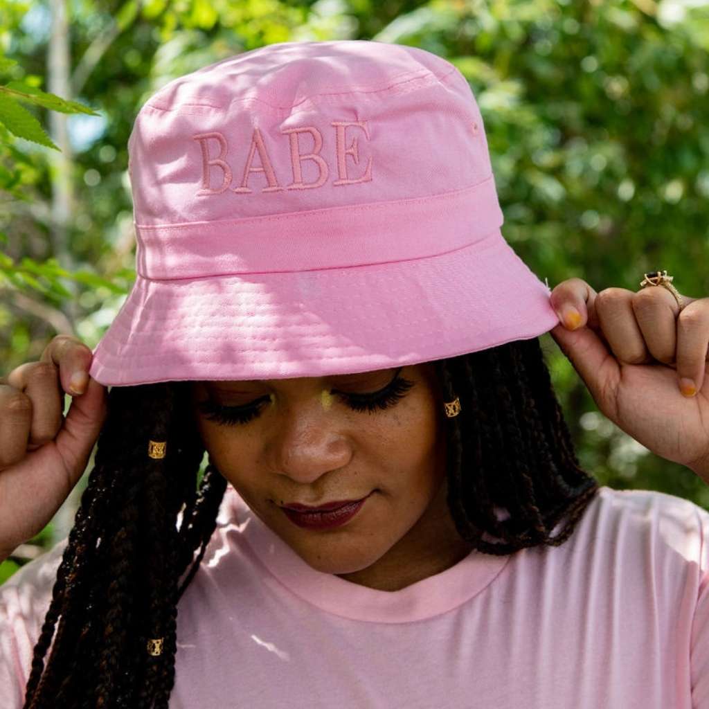 Female wearing a pink bucket hat embroidered with Babe with Pink  thread- DSY Lifestyle