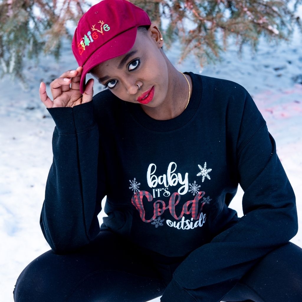 Female wearing a black sweatshirt with Baby it&