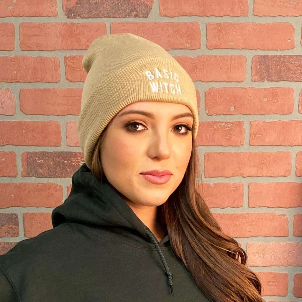 Model wearing tan cuffed beanie with BASIC WITCH embroidered in white - DSY Lifestyle